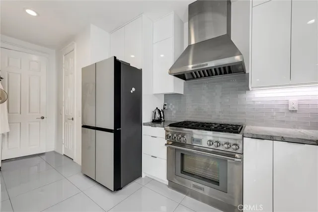 a kitchen with stainless steel appliances granite countertop a stove a refrigerator and a sink