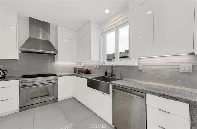 a kitchen with stainless steel appliances granite countertop a sink and stove top oven