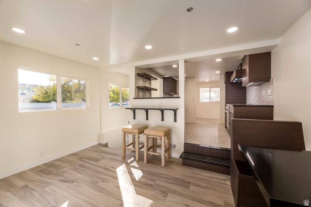 4658 Box Elder Street Salt Lake City, UT 84107 - Photo 8 of 17 Open-concept living space featuring wood-finish flooring, recessed lighting, and multiple windows for abundant illumination