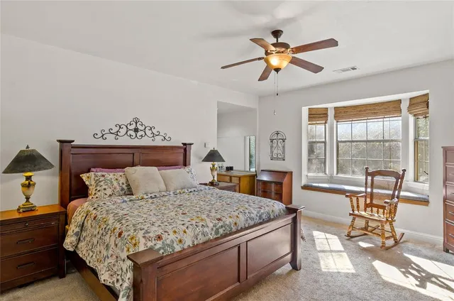 a bedroom with a large bed and a large window