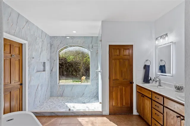 a bathroom with a double vanity sink and a mirror