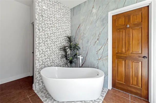 a bathroom with a bathtub and shower