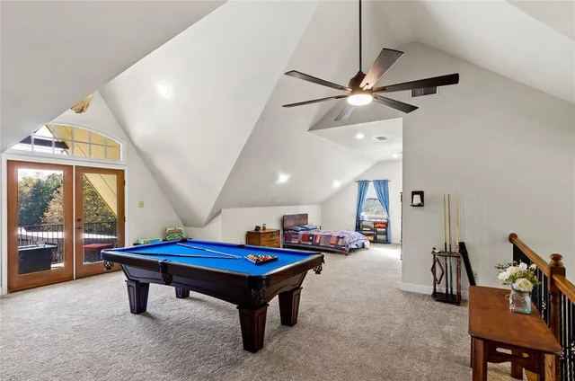 a room with pool table and windows