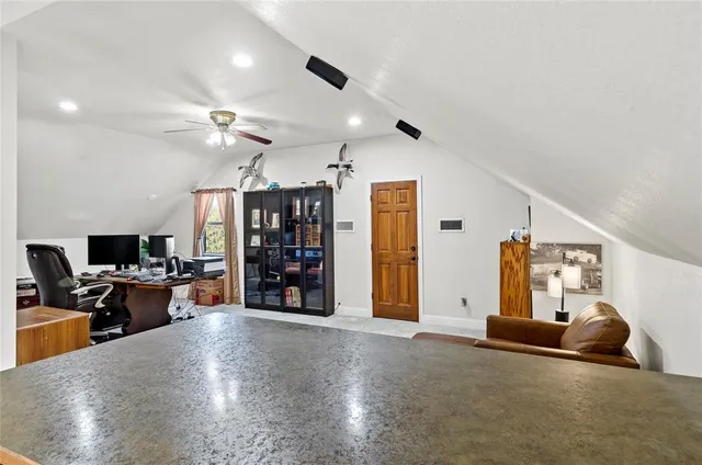 a view of a livingroom with workspace and a window