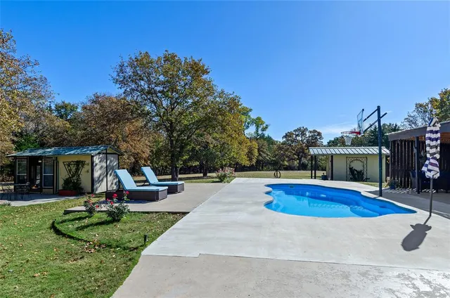 a view of a house with swimming pool and sitting area