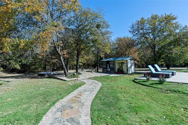a view of a chair and table in the garden