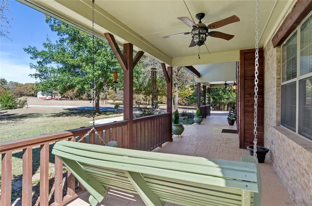 a view of a porch with furniture and a yard
