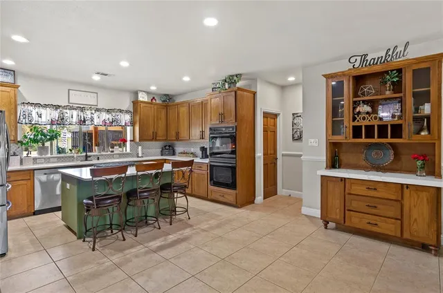 a kitchen with stainless steel appliances granite countertop a refrigerator and a stove top oven
