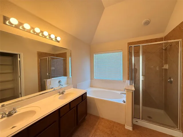 a bathroom with a bathtub and a sink