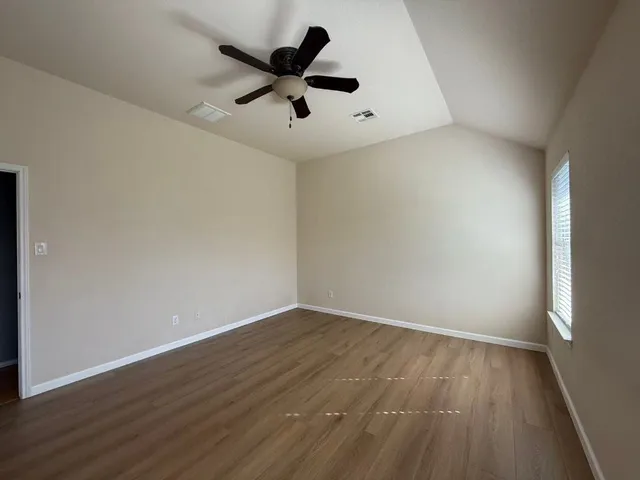 a bathroom with a sink a toilet a mirror a bathtub and shower
