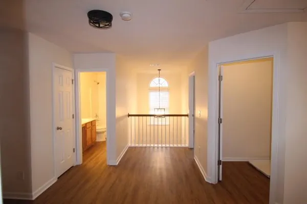 a view of a room with wooden floor and a window