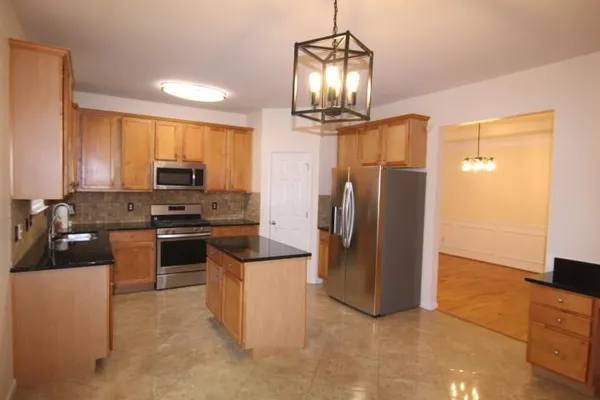 a kitchen with stainless steel appliances a refrigerator stove and sink