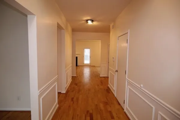 a view of a hallway with wooden floor