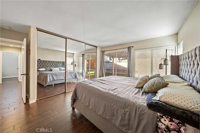 a bedroom with a bed and large glass window