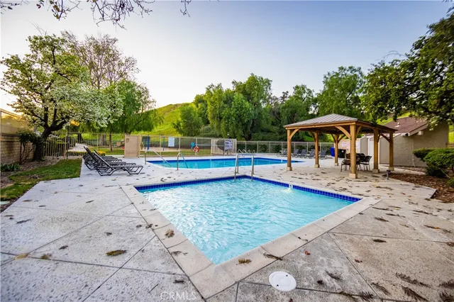 swimming pool view with a seating space