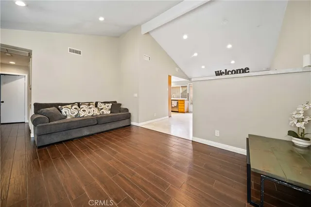 a view of a room with wooden floor and furniture