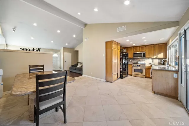 a view of kitchen with furniture and stainless steel appliances