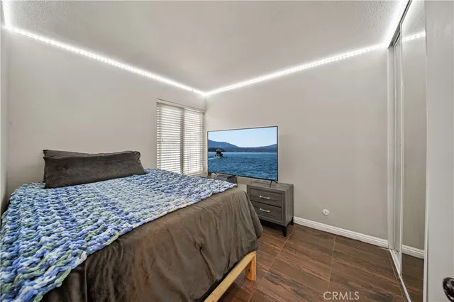 a bedroom with a bed and wooden floor