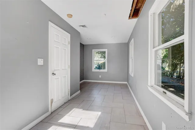 a view of entryway with window and front door
