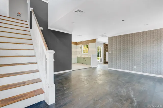 a view of entryway with wooden floor and stairs