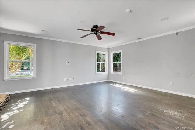 a view of a livingroom with a ceiling fan window and a ceiling fan