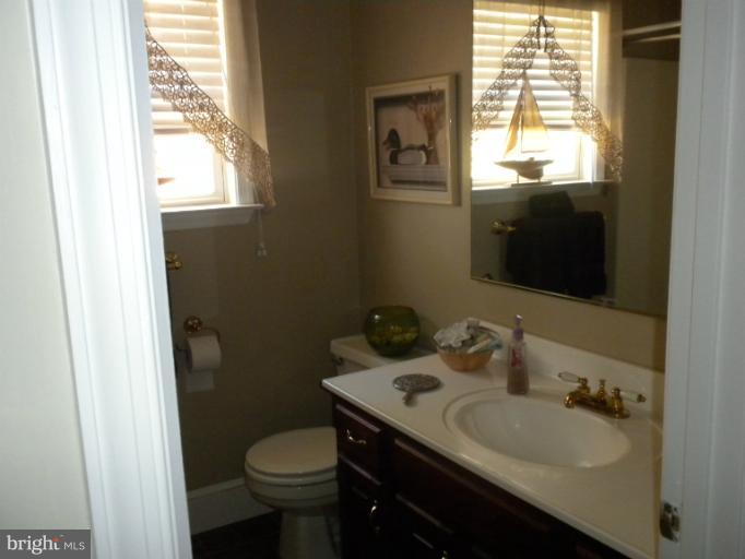1721 Ball Road Port Republic, MD 20676 - Photo 14 of 25 a bathroom with a granite countertop toilet sink and mirror