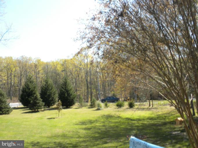 1721 Ball Road Port Republic, MD 20676 - Photo 21 of 25 a view of a swimming pool with trees in the background