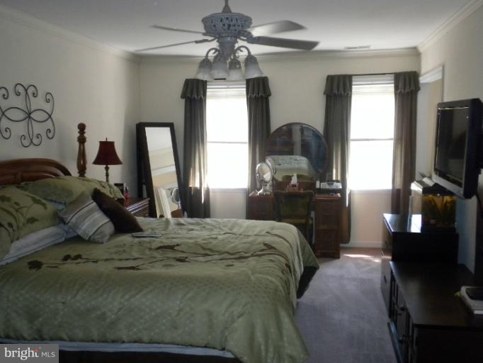 1721 Ball Road Port Republic, MD 20676 - Photo 9 of 25 a bedroom with a bed and a flat tv screen on dresser