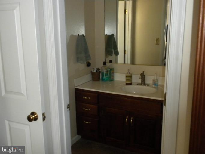 1721 Ball Road Port Republic, MD 20676 - Photo 10 of 25 a bathroom with a granite countertop sink and a mirror