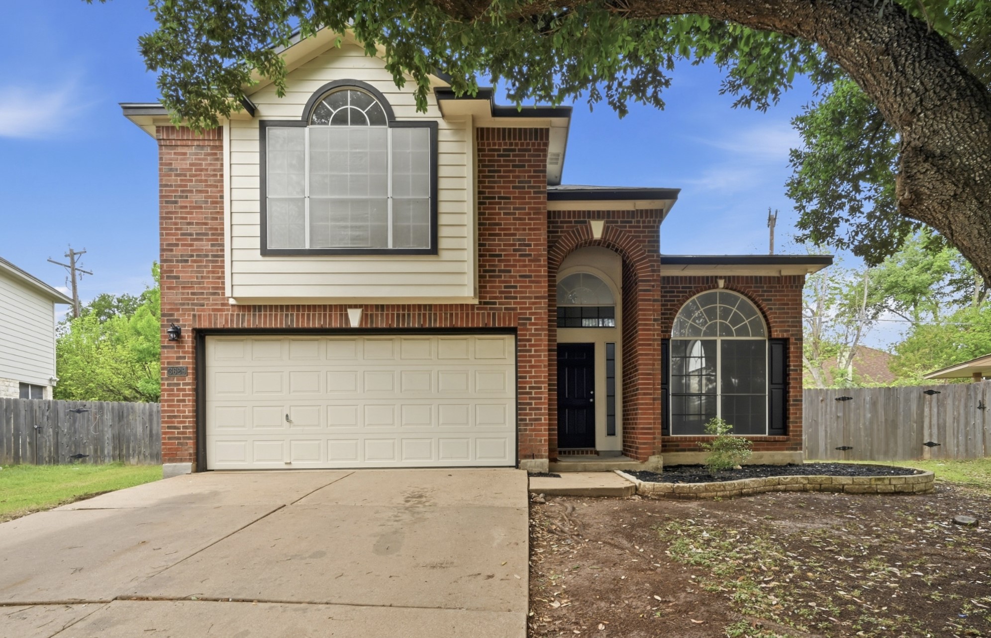 3629 Ruby Red Drive Austin, TX 78728 - Photo 3 of 35 Traditional-style house with brick siding and an attached, single-door garage