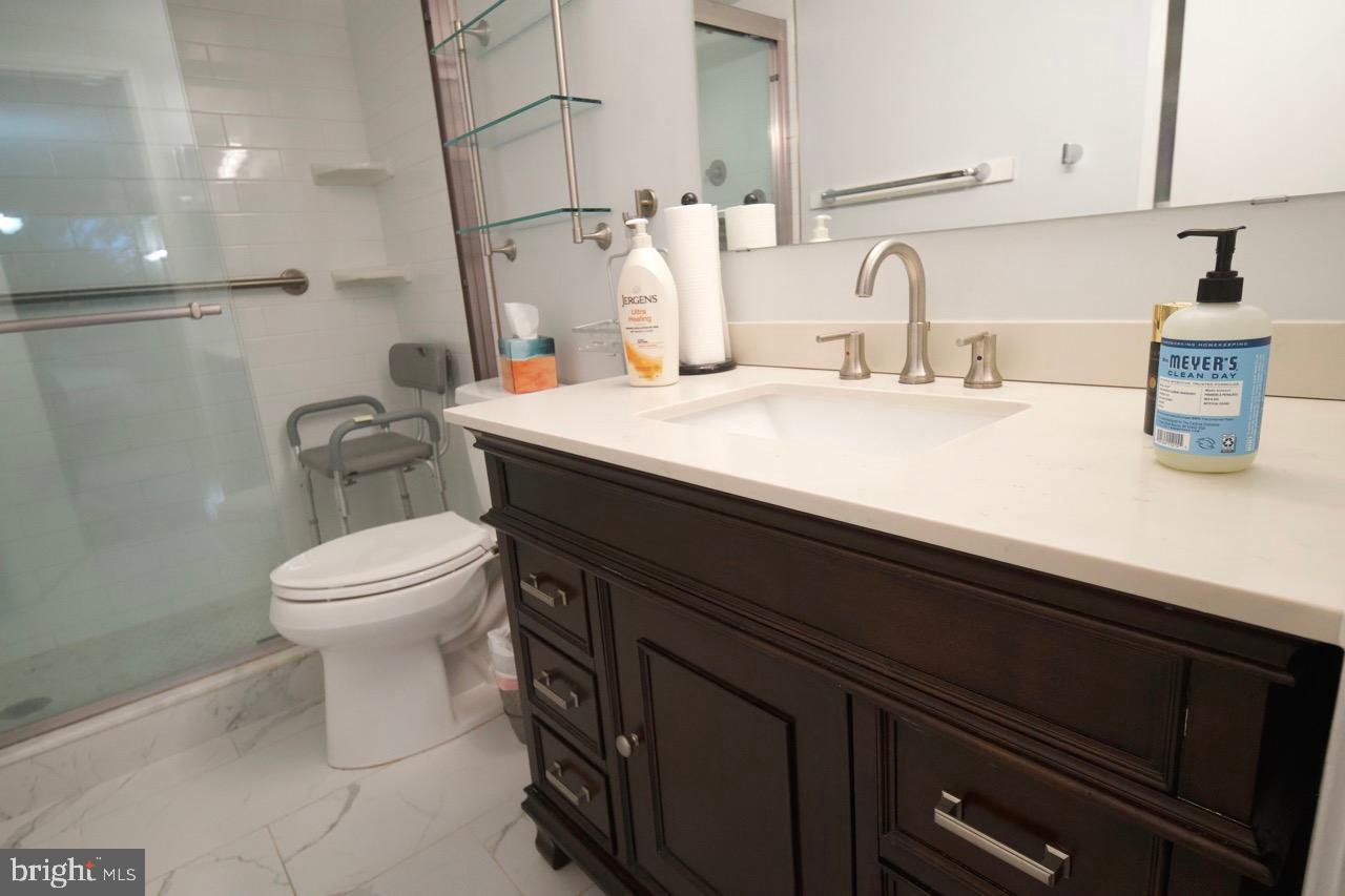 1800 Old Meadow Road, Unit 818 McLean, VA 22102 - Photo 21 of 35 a bathroom with a sink a toilet and a mirror