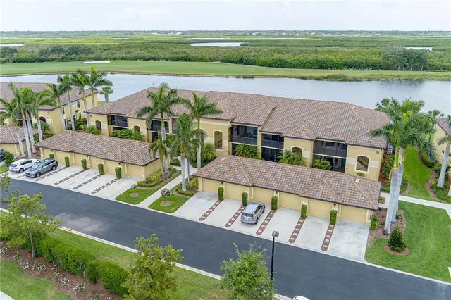 an aerial view of house with outdoor space and lake view