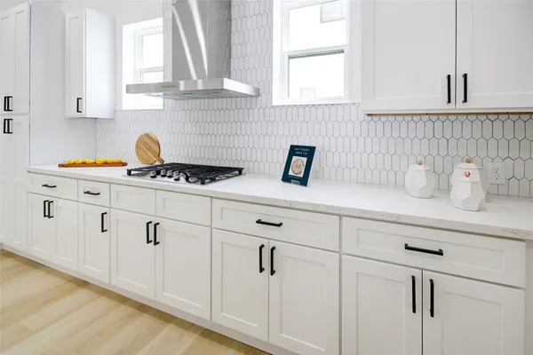 a kitchen with white cabinets and white appliances