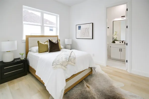 a spacious bedroom with a bed and a window