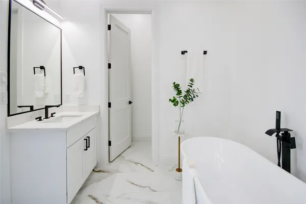 a bathroom with a bathtub and a sink