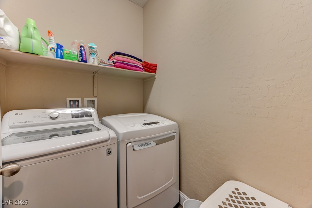 10281 Numaga Road Las Vegas, NV 89178 - Photo 15 of 41 Laundry area with separate washer and dryer and a textured wall
