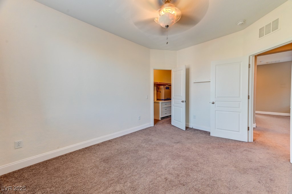 10281 Numaga Road Las Vegas, NV 89178 - Photo 17 of 41 Unfurnished bedroom featuring light carpet and ceiling fan