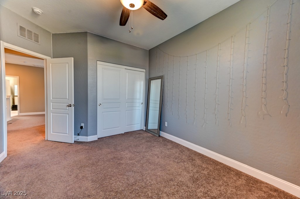 10281 Numaga Road Las Vegas, NV 89178 - Photo 22 of 41 Unfurnished bedroom featuring carpet, a closet, and ceiling fan