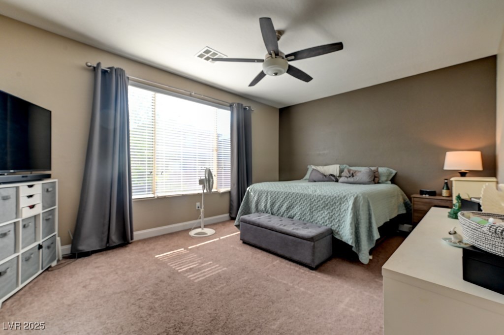 10281 Numaga Road Las Vegas, NV 89178 - Photo 28 of 41 Bedroom with light colored carpet and a ceiling fan
