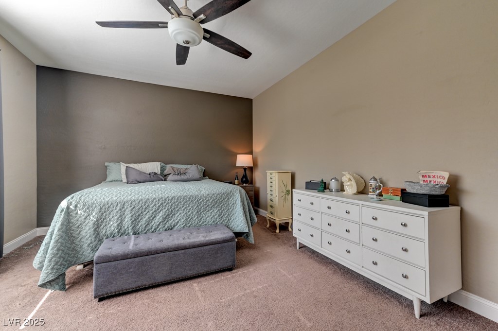 10281 Numaga Road Las Vegas, NV 89178 - Photo 29 of 41 Bedroom with light carpet and a ceiling fan
