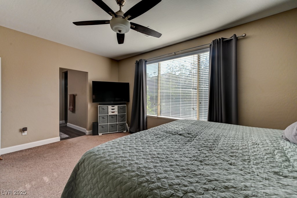 10281 Numaga Road Las Vegas, NV 89178 - Photo 30 of 41 Carpeted bedroom featuring ensuite bathroom and a ceiling fan