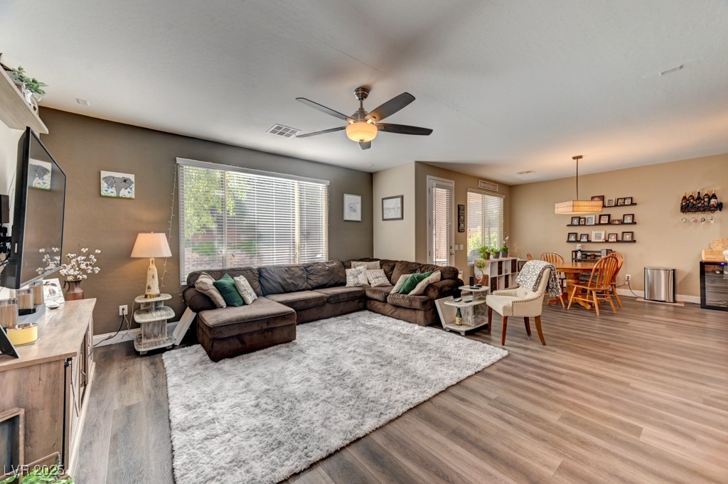 10281 Numaga Road Las Vegas, NV 89178 - Photo 3 of 41 Living area featuring plenty of natural light, light wood finished floors, and a ceiling fan