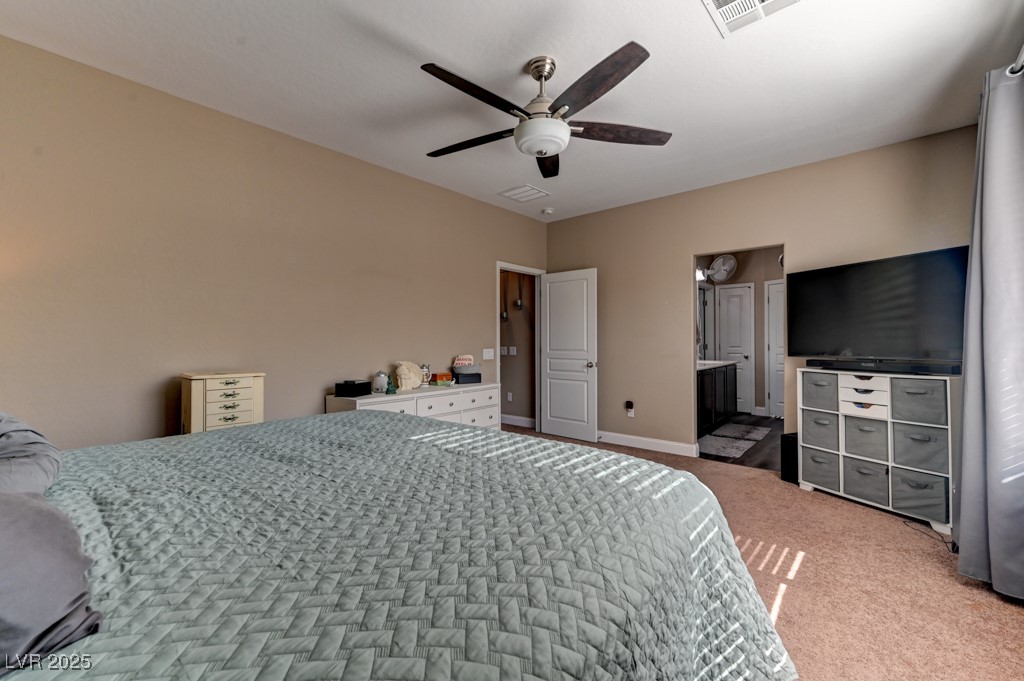 10281 Numaga Road Las Vegas, NV 89178 - Photo 31 of 41 Carpeted bedroom featuring ceiling fan and ensuite bath