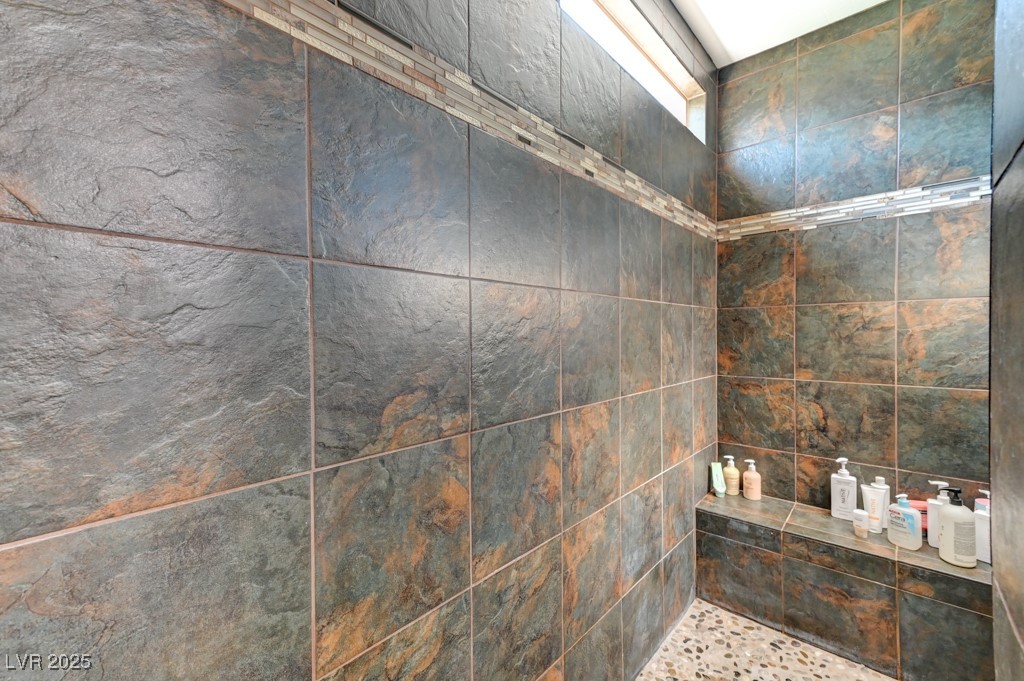 10281 Numaga Road Las Vegas, NV 89178 - Photo 33 of 41 Bathroom featuring a tile shower
