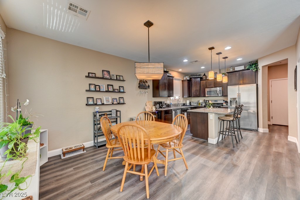 10281 Numaga Road Las Vegas, NV 89178 - Photo 5 of 41 Dining room with light wood-style floors and recessed lighting