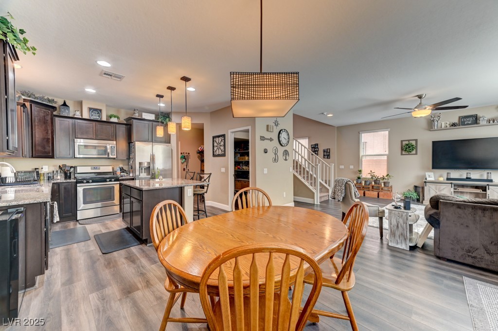 10281 Numaga Road Las Vegas, NV 89178 - Photo 6 of 41 Dining room with stairway, light wood-style flooring, recessed lighting, and ceiling fan
