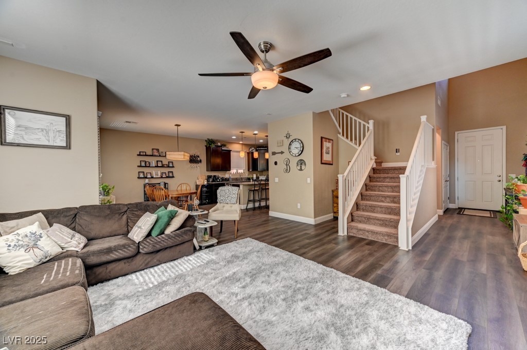 10281 Numaga Road Las Vegas, NV 89178 - Photo 8 of 41 Living area with stairway, dark wood-type flooring, a ceiling fan, and recessed lighting