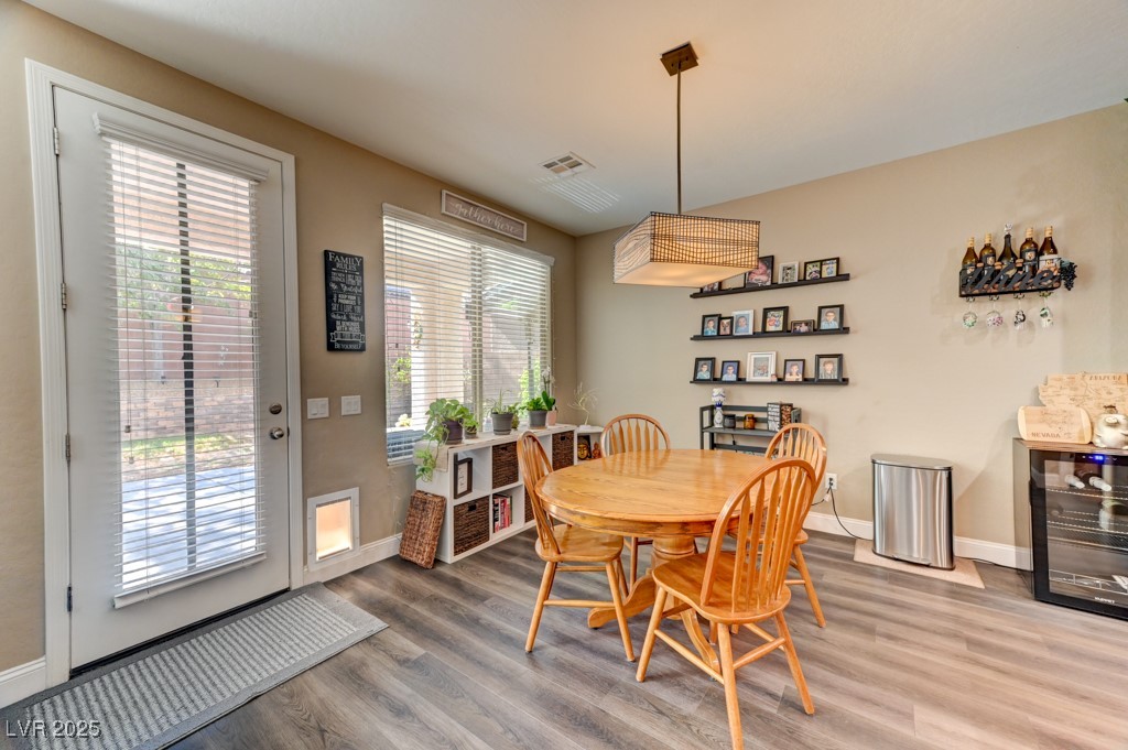 10281 Numaga Road Las Vegas, NV 89178 - Photo 9 of 41 Dining area featuring wood finished floors and baseboards