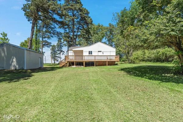 a view of a house with a yard and sitting area