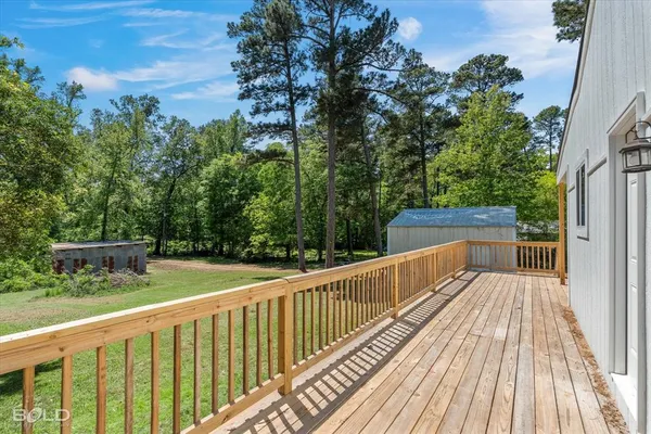 a view of balcony with wooden floor and fence